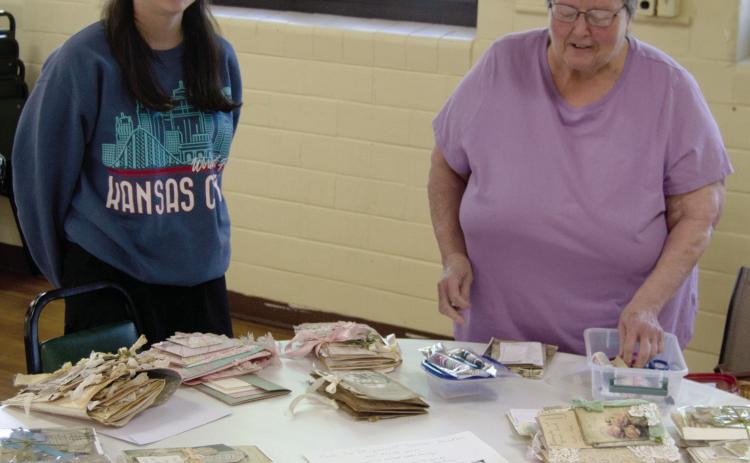 The 13th annual scrap book day at St. Bridgets in Scammon had more than 55 participants. During the session Saturday morning Laryn Keller and her grand mother Marilyn Keller taught a class on book binding the scrap books.