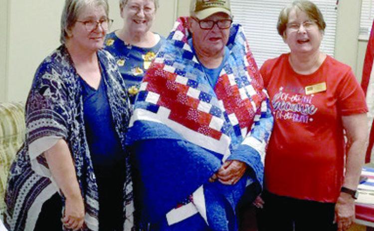 A Quilt of Valor was presented to Thomas Mounce of Miami, Okla., by Creating Quilts of Valor. at the monthly meeting of the Baxter Springs American Legion Post 206 September 13. Mounce served in the Army from 1969-1989, with duty stations including Vietnam, three tours Germany, and Fort Sill and Fort Hood. Courtesy photo.