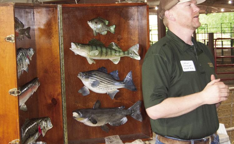 Kansas Department of Wildlife and Parks representative, Connor Ossowski presented the different fish found throughout Kansas at a recent Earth Day event for fourth and fifth graders. News Report photo by Tanya Woolsey.