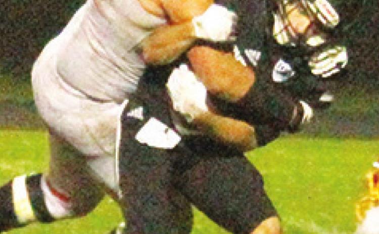 Titan Senior, Kody Schalk, takes down the Raider ball carrier deep in the backfield during the Columbus loss in Frontenac, 26-6, Friday.