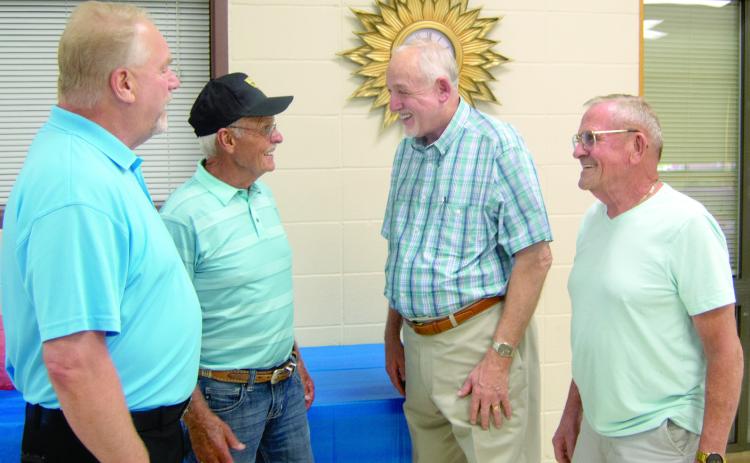 Executives with the United Mine Workers Union met briefly during the 26th annual retirees dinner held in Pittsburg Saturday evening. International Representative of District 12 Tim Miller chats with Pittsburg Local President Jim Lovell, International District 12