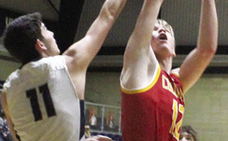 Galena Senior, Hadley Price, fouls Titan Junior, Cole Youngblood, on his shot for a Columbus and-one in the 40-47 loss to the Bulldogs in Galena, Tuesday. Cole led the Titans with 12 points off the bench.