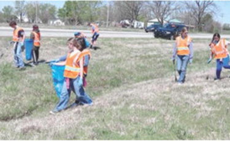 Southeast seventh grade students participated in a day of service April 8. Groups picked up trash along Highway 7 and cleaned headstones in the Cherokee Cemetery and completed other grounds maintenance. Courtesy photo.
