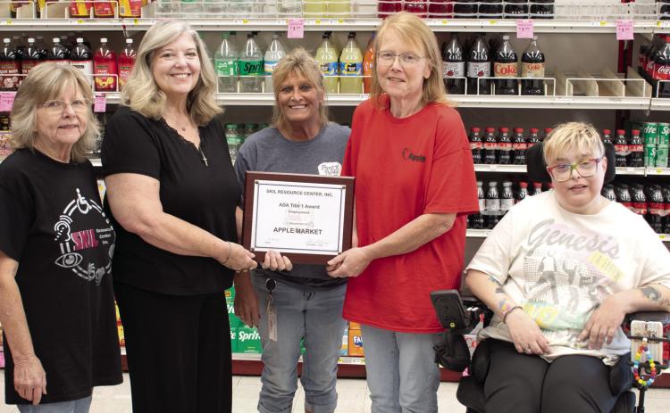 In recognition of their community impact in employing qualified persons with disabilities, SKIL Independent Living Advocate Jeanette Graham, SKIL President and CEO Shari Coatney and Tara Frasier (far right) also a SKIL Independent Living Advocate, present an award to the Columbus Apple Market. Apple Market assistant manager Kristy Jameson and manager Candy Phillips received the award on behalf of the store.