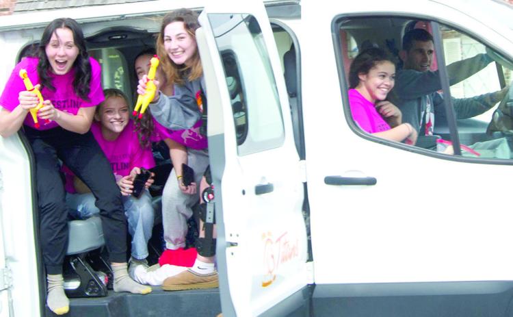 Lady Titan Wrestlers heading to the Kansas Class 4-1A Girls Wrestling State Tournament enjoyed a send off parade for both the girls and boys teams. Senior, Katie Simpson, junior, Emily Britt, freshman, Hannah Noel, senior, Madelyn Garcia, and senior, Brooklyn Lima, were driven to Salina by Titan Head Wrestling Coach, Marcus Bowman. The tournament will take place Thursday through Friday at the Tony’s Pizza Event Center.