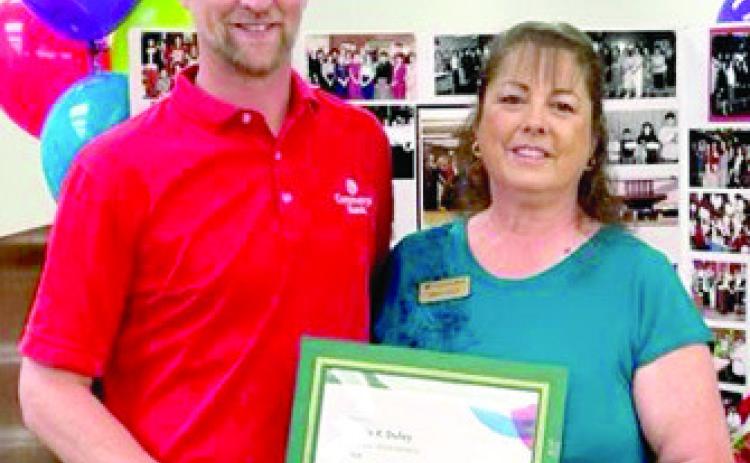 Wade Schossow presented Sonja Duley a certificat in recognition of her 40 years with Commerce Bank at a reception Friday. Courtesy photo.