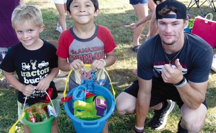 In Saturday’s Freedom Fest, sponsored by the Columbus Fire Department, Craighton Duley and Oliver Siemer won the boys under six years old sack race competition. Firefighter Austin Hoiser presented the prizes.