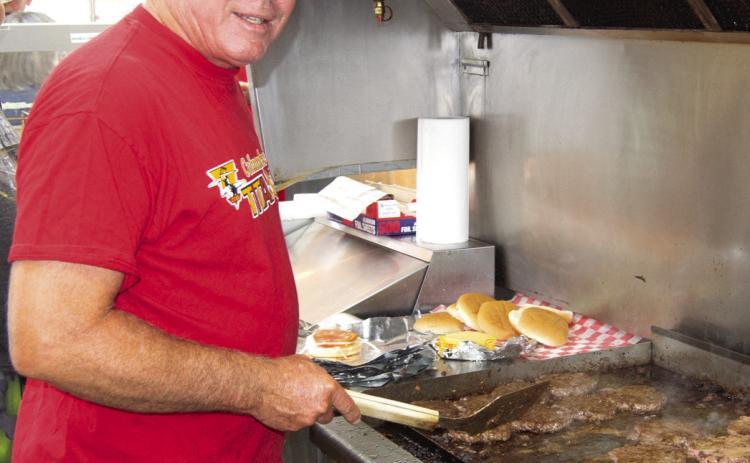 Columbus Lions Club member Mark Winter was manning the grill for the Booster Club fundraiser before Friday nights game against Afton.