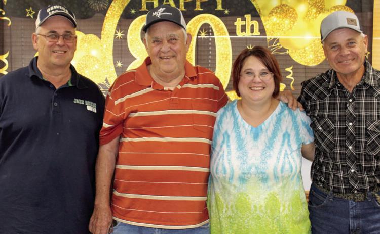 Lyman Crain (second from left) recently celebrated his 80th birthday. His children John Crain, Julie Thomas and Tim Crain hosted the party at the 4-H Building. Family and friends joined in the celebration.