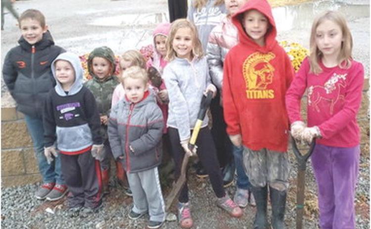 The planter box at the Cherokee County Extension Office recently had some new flowers installed. The Heritage Youth of America, a newly formed youth development group planted mums. Those helping included Isaac Zahm, Sawyer Gregory, Jessee King, Ellie Gregory, Eli Zahm, Jael King, Elizebeth King, Katherine King, Lucy Zahm, Samuel King and Adalynn Garner. Courtesy photo.