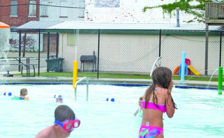 Youngsters were ready for the Scammon pool to open Saturday as they turned out for the event which was suddenly dampened by a short rain. New features in the kiddy pool have been added.