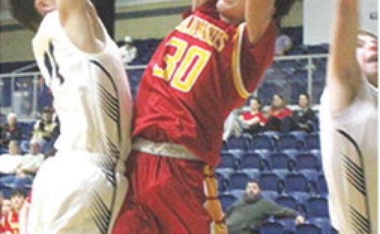 Titan Junior, Drake Laurance, fails to draw a foul against his Galena defenders on his attempted shot in the 29-58 loss to the Bulldogs in Galena, Tuesday.