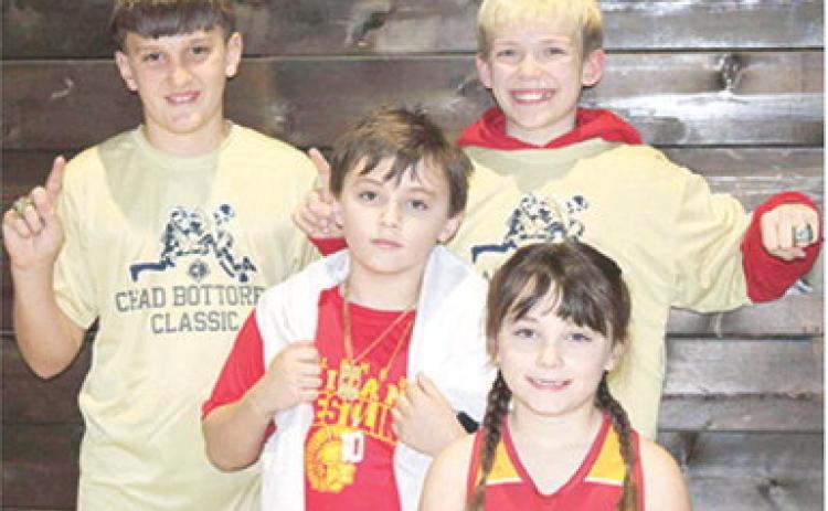 Briggs Johnson, Bearett Bowin, Lucas Natalini, and Jolie Bowin wrestled at the Chad Bottorff Memorial Classic Wrestling Tournament, Saturday, in Springdale, Ark. Jolie placed fourth and all the boys brought home gold rings. Courtesy photo.