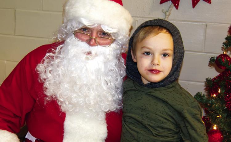 Maverick Wise was talking with Santa Sunday following the Scammon Christmas Parade. The traditional cookie and hot chocolate treats for the kiddies and visit with the jolly elf from the North Pole.(Right)