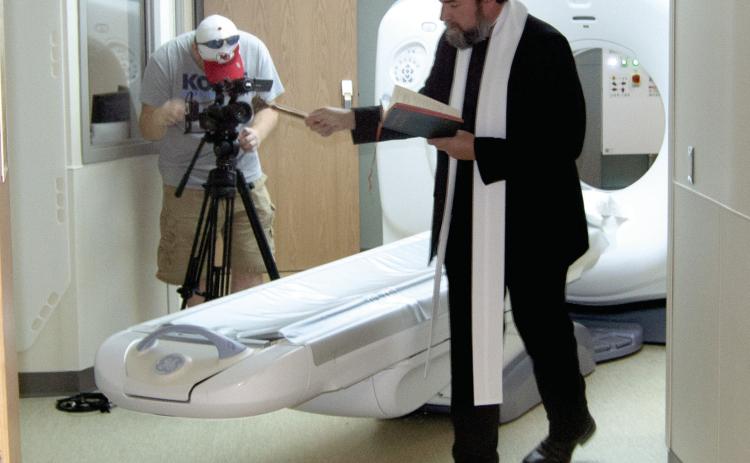 Father Jeremy Huser was at the Columbus Mercy Hospital to bless the newly installed CT machine. The staff has been trained to operate the equipment.