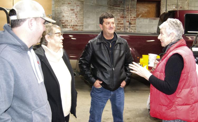 Hammer Tires and Service employee Mike Bartling visits with Chamber of Commerce Director Jean Pritchett and Cherokee County Economic Development Director David Stricklin, and Chamber of Commerce president Laura Lowry Greene talk about business practices.