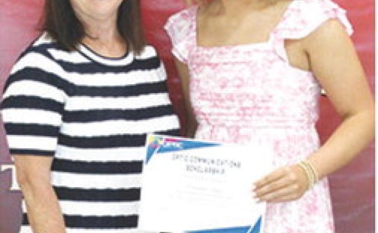 Kenadie Carter received a $1,000 Optic Communications Scholarship from Jane Rhinehart during the 2025 Senior Assembly at the CUHS Gymnasium, May 16.