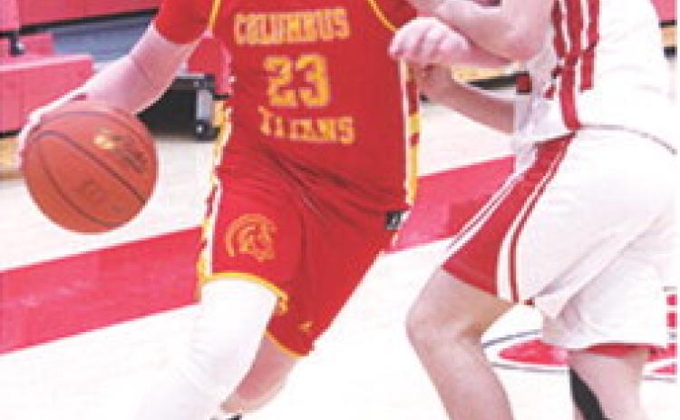 Jex Cheney drives to the basket past Baxter Springs defender, Caster Herrera, in the Monday loss on the road, 20-28. Cheney led the Titan Eighth Grade Team with eight points.