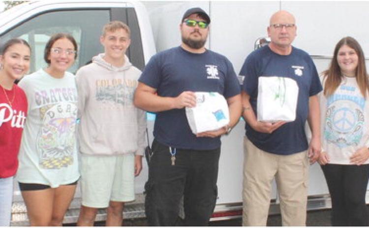 Cherokee County Ambulance personnel Kyle Darnell and Les Flood stopped by the Veterans and First Responder Appreciation Dinner Monday, September 11. Presley Tedlock, Katy Mooney, Korbyn Newberry, Jaiden Campbell and Britney Degonia assisted with assembling and passing out meals during the event.