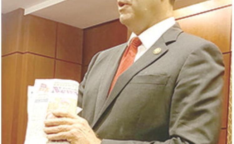 Even politicians in Washington carry something worth reading. Congressman Derek Schmidt had a copy of the recent issue of the News-Report. He said he was particularly interested in the news story about local beef being electrocuted by high power electric lines. Courtesy photo.