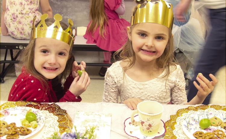 Park Elementary Kindergarteners dressed up and enjoyed a Royal tea party recently. PaisLee Stoner and Sadie Stradley, dressed as princesses, snacked on pretzels, cheese and grapes while having their tea. News Report photo by Tanya Woolsey.