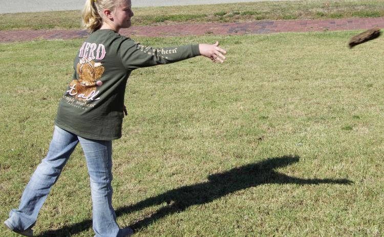 Some new events were held at the museum during the Columbus Day Festival. One of those events was the cow patty tossing contest. Ryleigh Holmes makes her best toss.