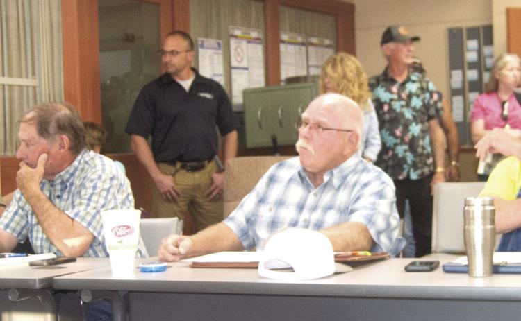 Planning Commissioners Roger Draeger, John Lopp, Randy Commons, and Scott Boyes are surrounded by the community members attending the meeting.