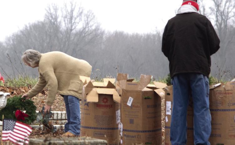 The fresh live wreaths arrived in several large cardboard boxes which were unpacked and taken to the individual grave sites.