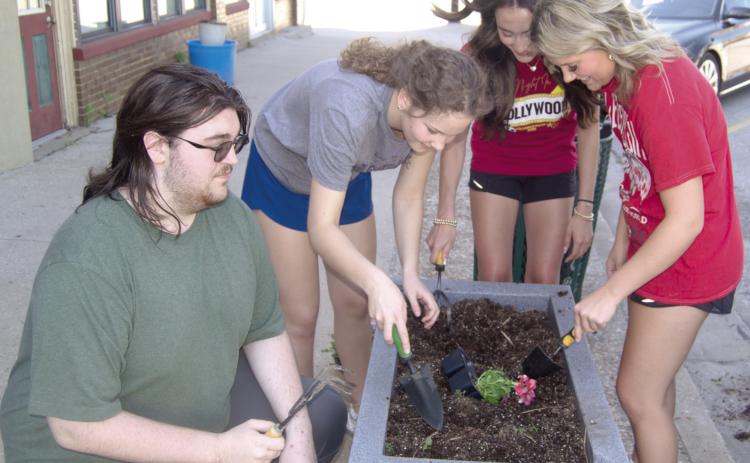 Members of Columbus High School National Honor Society filled area planters with flowers before the end of the school year. Those helping included Robert Graham III, Ruby Stover, Faith Williams and Kenadie Carter.
