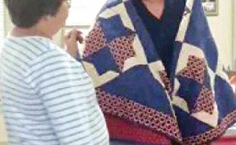 Kathi Lunday with the Pittsburg Quilts of Valor program recently presented Vietnam Veteran Wayne Cook with a quilt in honor of his military service. Photo by Dee Riley.