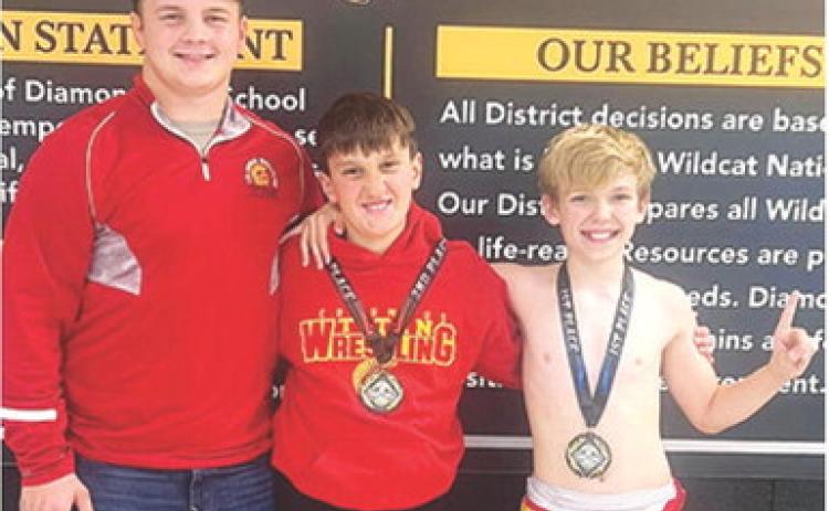 Columbus Wrestling Club Members, Trent Smith, coach; Briggs Johnson (second); and Lucus Natalini (first), participated in the Diamond Youth Open Tournament, Saturday in Diamond, Mo. Courtesy photo.
