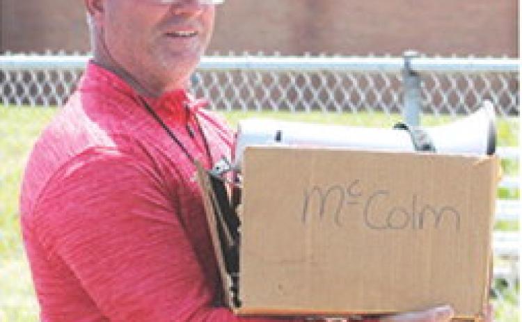 Columbus Elementary School Physical Education Coach, Heath Perry, had his hands full with the All-School Elementary Track and Field Meet Friday at Central School. Students in K-6 and teachers competed in various events from 9:30 a.m. to 2:30 p.m.