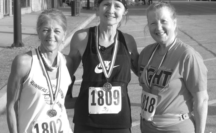 In the female over 60 division of the Columbus Days 5K run Turia Smith, West Mineral, (center) took first place honors with a time of 27.54. Kathy Richart, Carthage, Missouri, was second (at left) with a time of 28:06 and (at right) Phyllis Kelly was third with a time of 35:35.