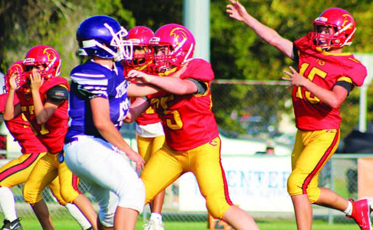 Titan Jex Cheney, and members of the seventh grade offensive line give quarterback, Jace Gaither, time to throw during the 28-34, Titan loss to Pittsburg, Monday, at Titans Stadium. The non-conference thriller ended in an overtime standoff won by the visiting Purple Dragons.