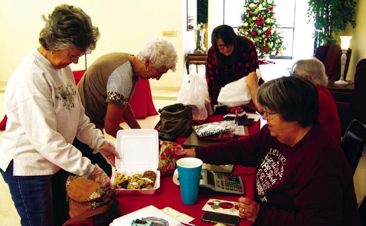 When the St. Bridgett’s Cookie Walk opened in Scammon Saturday morning the lines had formed outside the Parish Hall and it never slowed down until the cookies were exhausted. Making a purchase were Joyce Forrest and JoAn Sullivan.