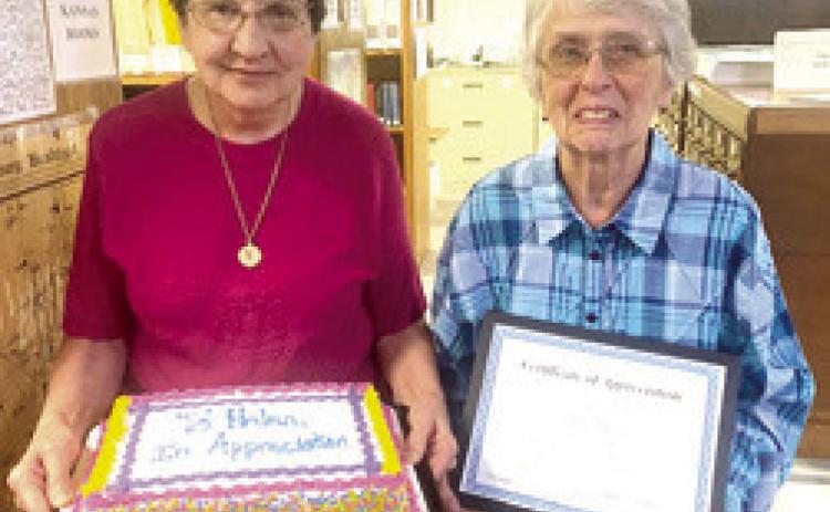 Long time volunteer at the Cherokee County Genealogical Society, Helen Kelley (right) was recently honored for her years of dedication and service. In her 30 years as a volunteer, Kelley has served as President of the Genealogical Society and helped raise funds for a new museum building. Kelley received a Certificate of Appreciation and Ella Buzzard presented her with a cake at the recent meeting. Courtesy photo.