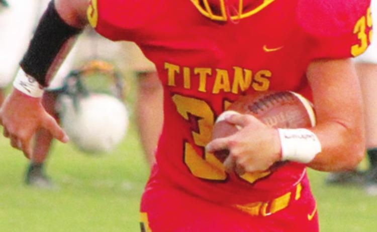 Titan Senior, Trent Smith, picks up yardage against Coffeyville in the 40-8, Columbus win, Friday at Titan Stadium. The Titans are in action tonight at Girard.