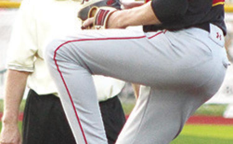 Umpire, Jay Wary, keeps a close eye on Titan Freshman Pitcher, Jonas Stover, as he tossed two strike outs and issued one walk with no hits and no runs to close out the final two innings of the win over the Trojans in Girard, Thursday.